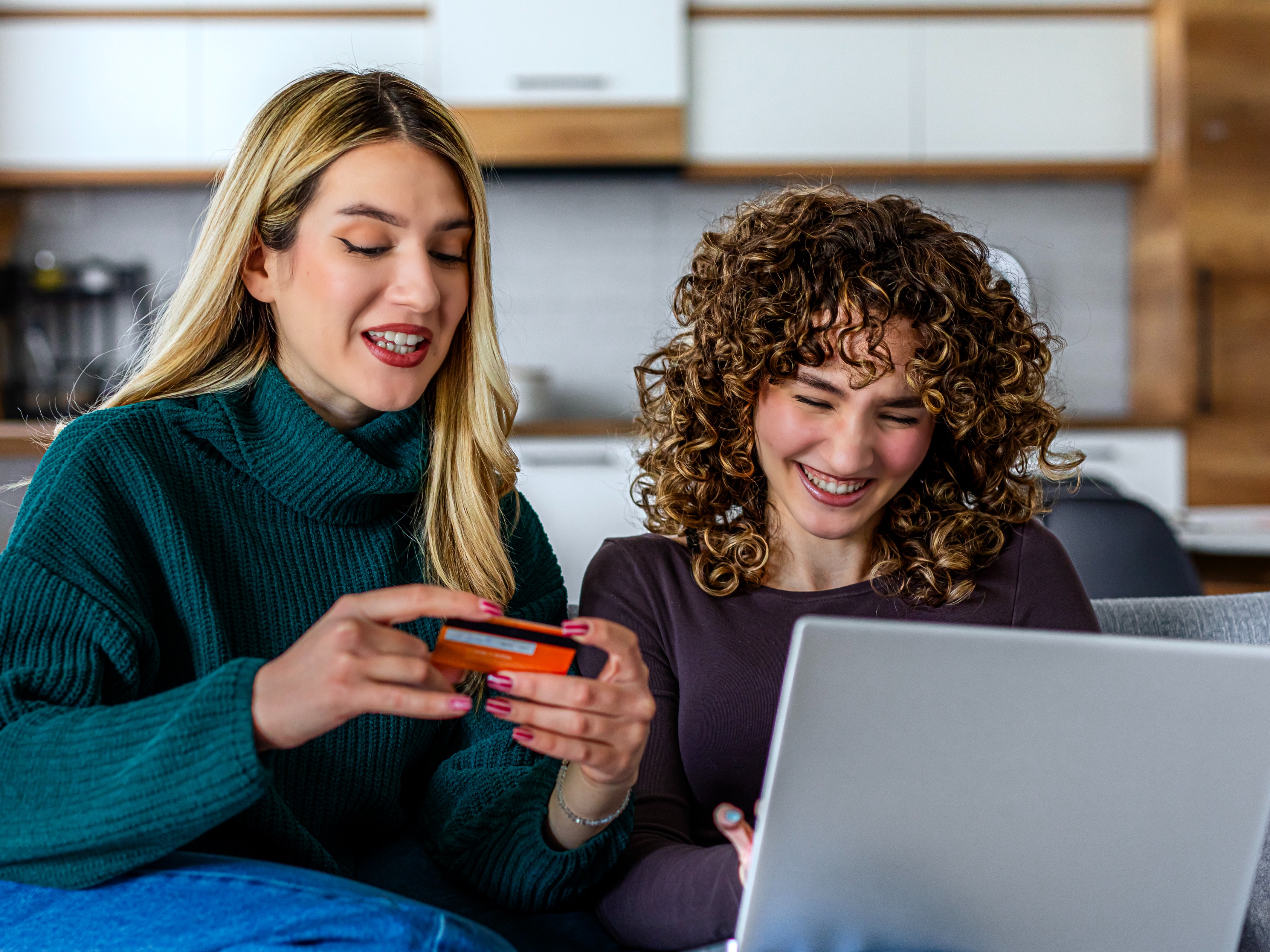 Mother and daughter using credit card online