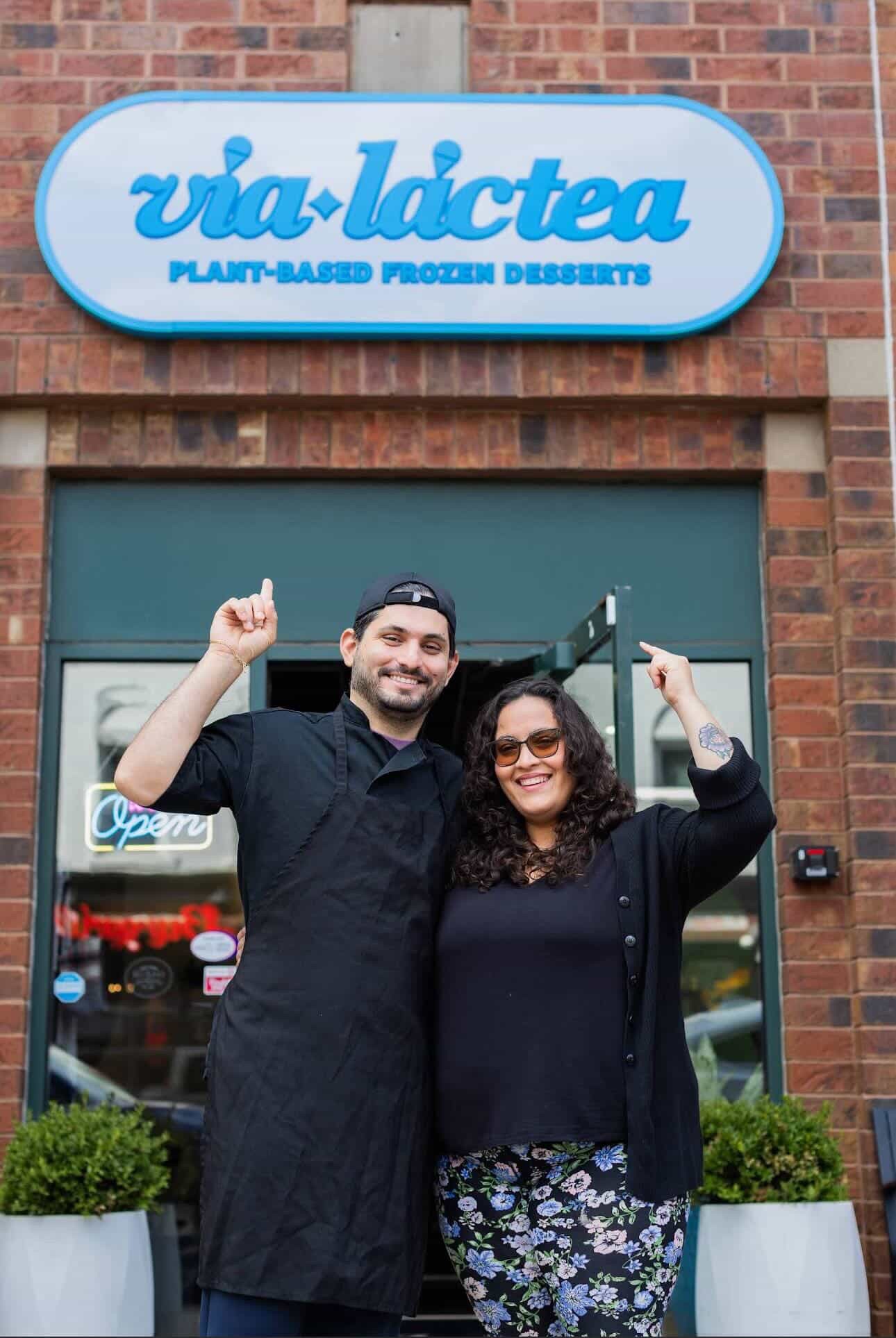 Business owners standing in front of their shop