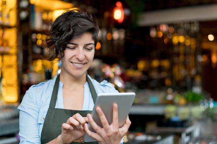 Shop owner using P O S tablet