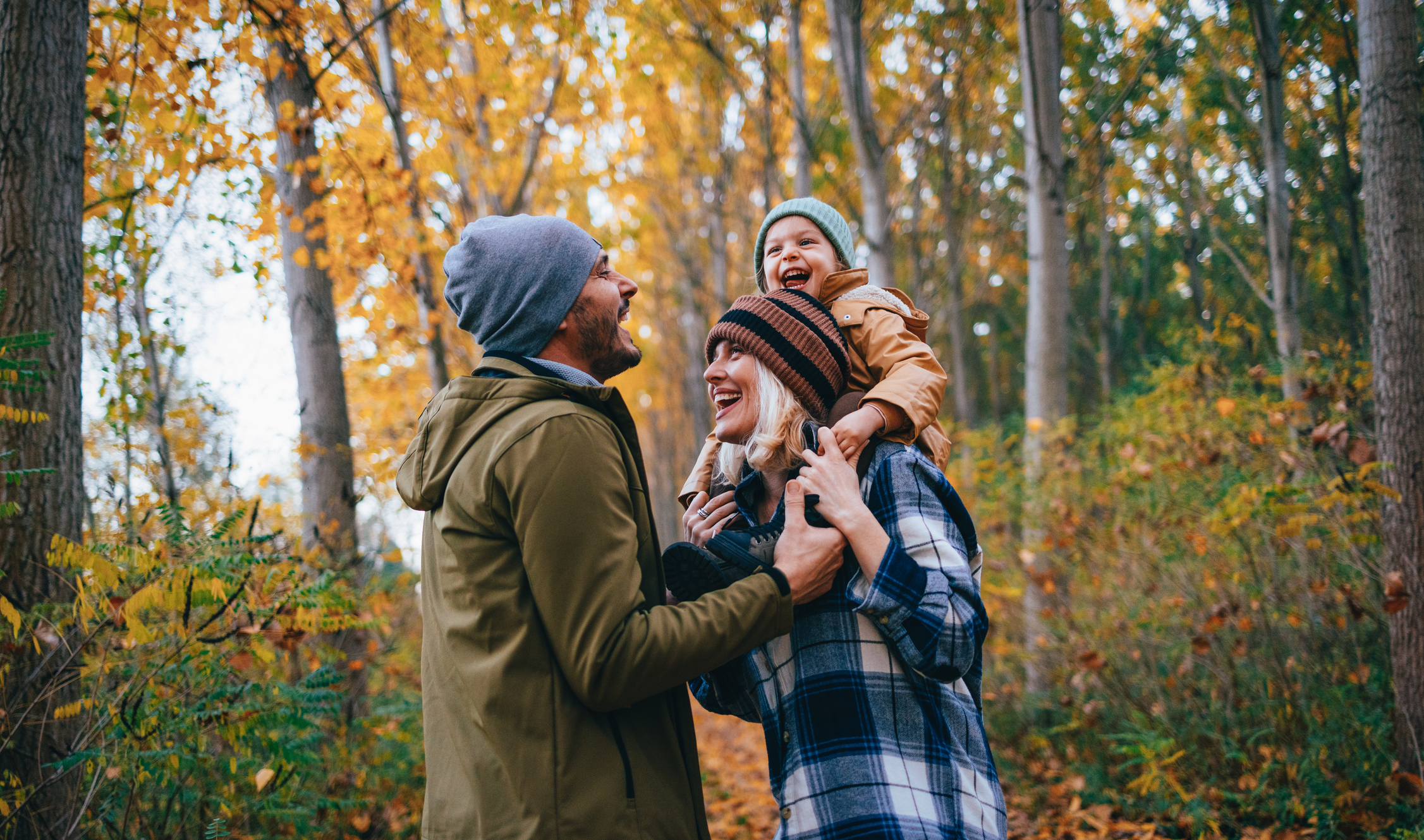 Family of three on a walk in the woods