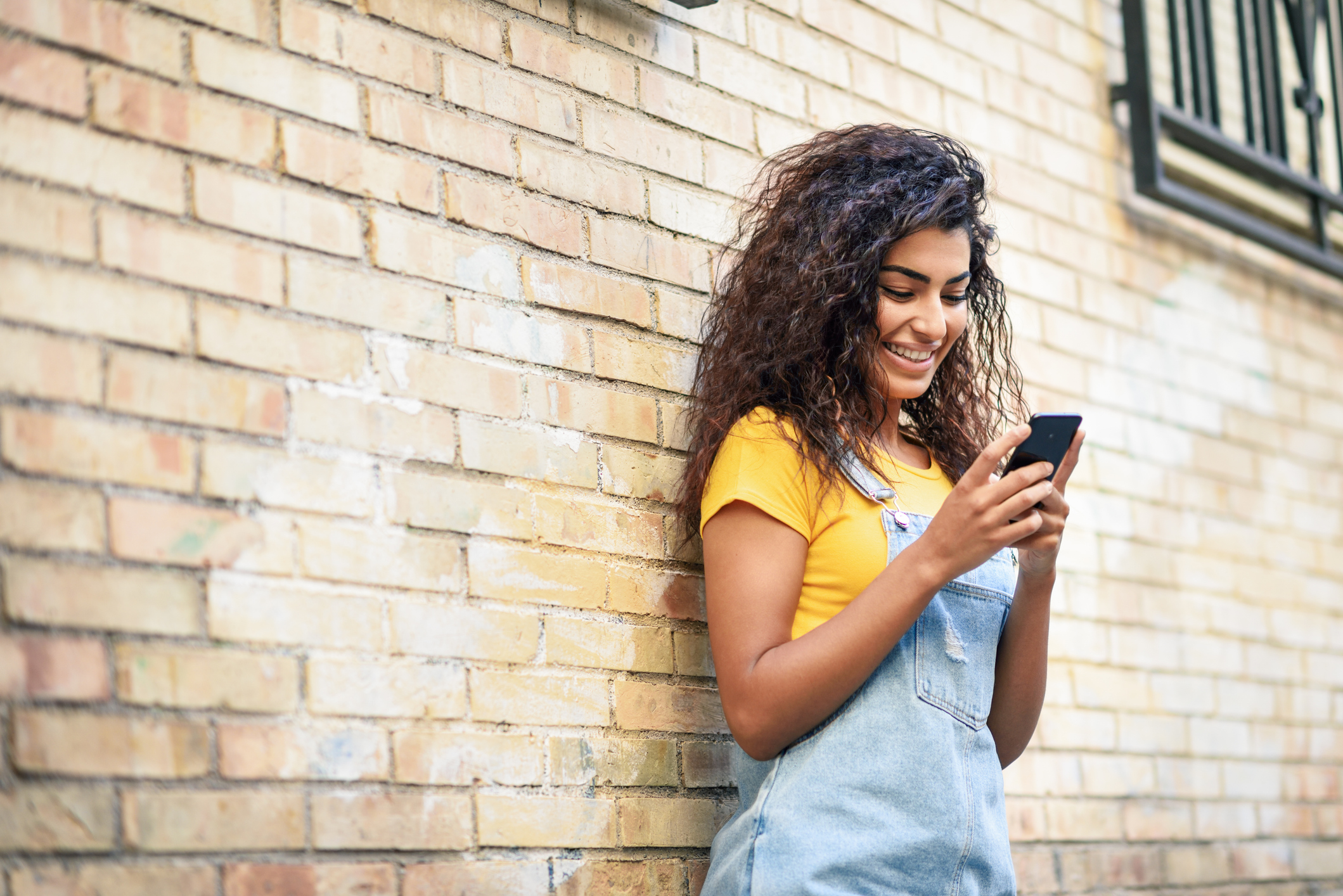 Woman texting with her smart phone outdoors