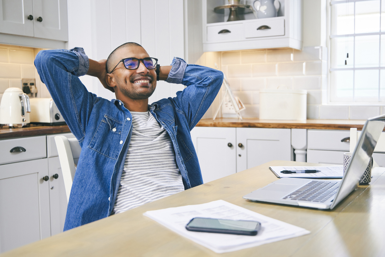Man in his kitchen at a laptop