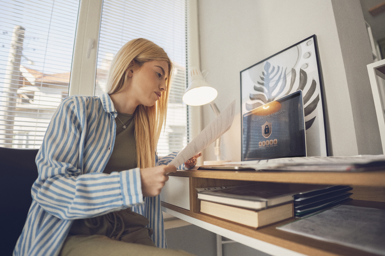 Woman Reviewing Bank Statements, Using Two-Factor Authentication