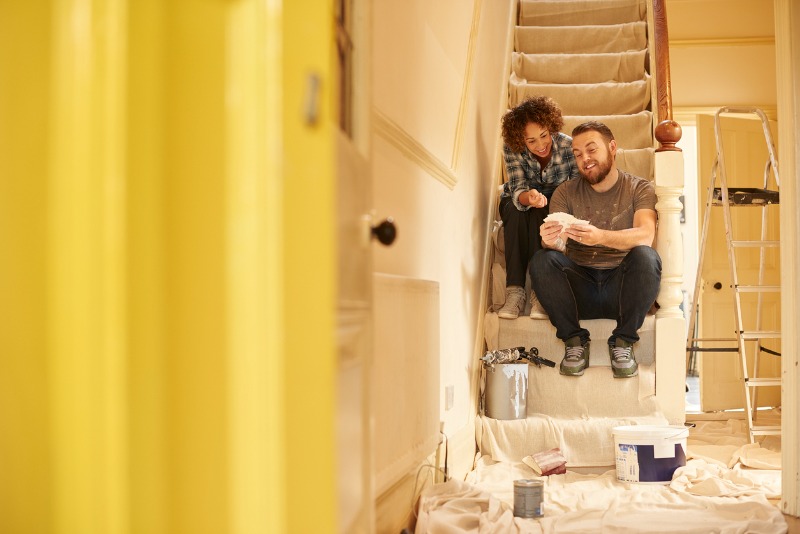 Couple looking at paint swatches in a renovation