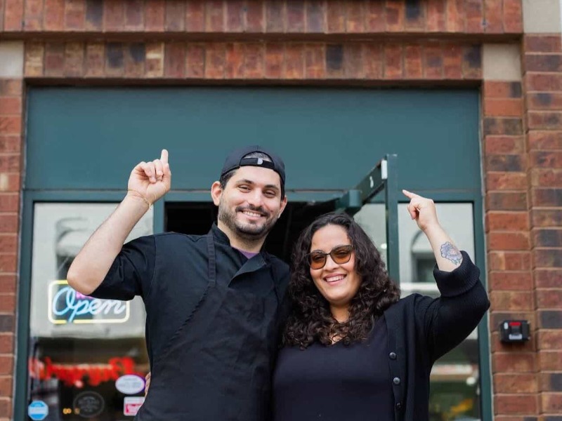 Business owners in front of their store