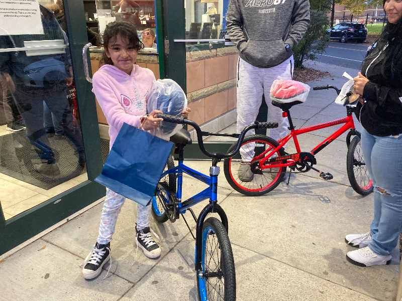 Young girl smiles with her new bike