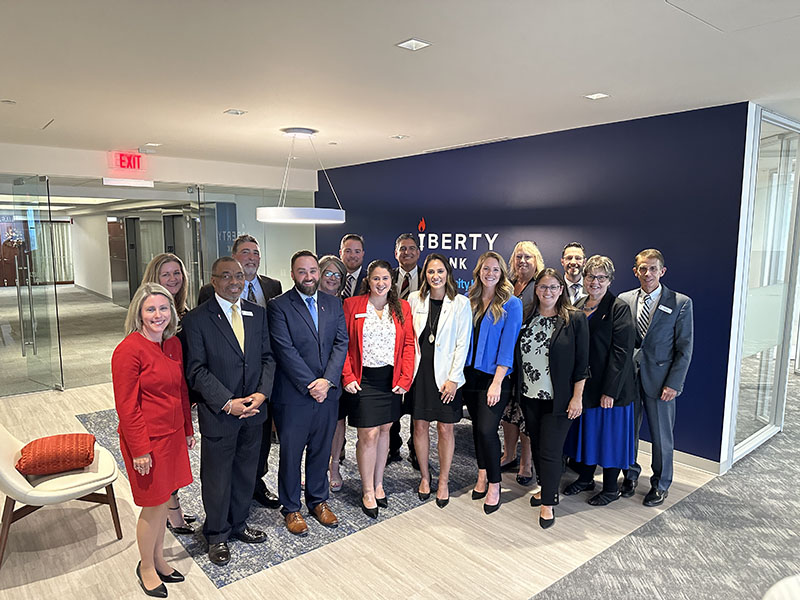 A group of Liberty Bank employees in a new modern office